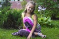 Liitle girl sitting on the grass