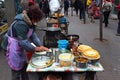 Lijiang, China - March 8, 2012: Street food vendor in Lijiang Old Town, the UNESCO Heritage Site and popular tourist destination Royalty Free Stock Photo