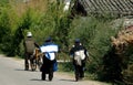 Lijiang Twp, China: Naxi People Walking on Road Royalty Free Stock Photo