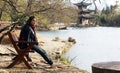 Lijiang view chinese garden with girl side view look forward in  Black Dragon Pool, Yunnan province Royalty Free Stock Photo