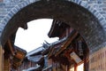 Stone arch and Chinese style roofs in the ancient city of Lijiang, Yunnan, China