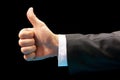 Like. Close up image of human hand with thumb up on black background Royalty Free Stock Photo