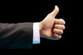 Like. Close up image of human hand with thumb up on black background Royalty Free Stock Photo