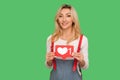 Like and follow social media blog. Portrait of lovely smiling adult woman holding network heart icon