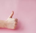 Like hand sign on a light trending pink background, Successful concept, female hand thumb up Royalty Free Stock Photo