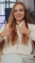 Happy young woman looking approvingly at camera showing thumbs up, like positive sign, good news Royalty Free Stock Photo