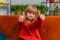 Happy child kid girl looking approvingly at camera showing thumbs up, like positive sign, good news Royalty Free Stock Photo