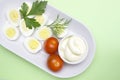 Overhead photo of vegetable salad with boiled quail egg, dill, fresh tomato and lettuce on white porcelain plate. A served salad p Royalty Free Stock Photo