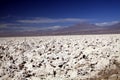 Like on the moon: View over endless bright white barren salt plateau into the nowhere contrasting with deep blue sky Royalty Free Stock Photo