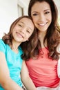 Like mother, like daughter. Portrait of a mother and a daughter smiling at the camera. Royalty Free Stock Photo