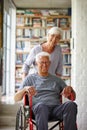 Like my wheels. Portrait of a senior woman pushing her husband whos in a wheelchair. Royalty Free Stock Photo