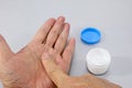 Like paint a topical cream for roughed his hands. Royalty Free Stock Photo