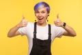 Like! Portrait of optimistic happy hipster woman showing double thumbs up and saying wow yes. yellow background, studio shot Royalty Free Stock Photo