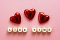 Like time words, made of wooden letters with red heart on pink background. Social media concept.