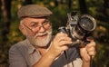 He likes birdwatching. Pension hobby. Experienced photographer. Vintage camera. Old man shoot nature. Professional