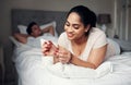 He likes it when I wear red. a young woman applying nail polish to her nails. Royalty Free Stock Photo