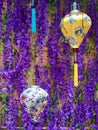 Lilac background with hanging Chinese lanterns of different colors. Chinese style fabric pendant lamps on purple background. Royalty Free Stock Photo