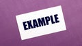 On a lilac background, a white card with the word EXAMPLE