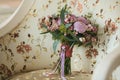 Lilac beautiful wedding bouquet with berries, standing on a white armchair with an overhead Royalty Free Stock Photo