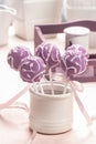 Lilac cake pops lavishly decorated with icing.