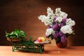 Lilac in a ceramic vase and a scale on the table Royalty Free Stock Photo