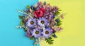 Lilac chrysanthemums, pink Tulip and lilies of the valley on a blue-yellow background. Bright flower arrangement. Royalty Free Stock Photo