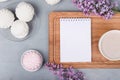 Lilac, coffee cup with latte art and marshmallow on white wooden table