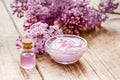 Lilac cosmetics with flowers and spa set on wooden table background Royalty Free Stock Photo