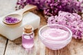 Lilac cosmetics with flowers and spa set on wooden table background Royalty Free Stock Photo