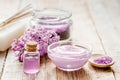 Lilac cosmetics with flowers and spa set on wooden table background Royalty Free Stock Photo