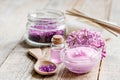 Lilac cosmetics with flowers and spa set on wooden table background Royalty Free Stock Photo