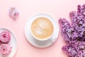 Lilac, cup of coffee, homemade marshmallow, notepad on pink background. Still life. Spring romantic mood. Top view Royalty Free Stock Photo