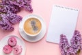 Lilac, cup of coffee, homemade marshmallow, notepad on pink background. Still life. Spring romantic mood. Top view Royalty Free Stock Photo