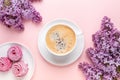 Lilac, cup of coffee, homemade marshmallow, notepad on pink background. Still life. Spring romantic mood. Top view Royalty Free Stock Photo