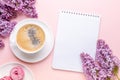 Lilac, cup of coffee, homemade marshmallow, notepad on pink background. Still life. Spring romantic mood. Top view Royalty Free Stock Photo