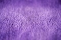 Lilac delicate soft background of fur plush smooth fabric. Texture of purple soft fleecy blanket textile