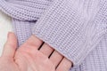 Lilac fabric knitted fabric sn female hand.