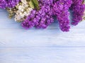 Lilac flower blossom bouquet on blue wooden background frame beauty