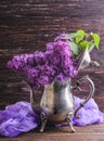 Lilac flowers in decorative vintage teapot