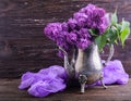 Lilac flowers in decorative vintage teapot