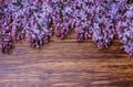 Lilac flowers on an old wooden board