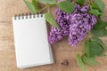 Lilac flowers and open blank notebook scrapbook on rustic wooden background Royalty Free Stock Photo