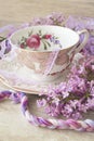 Lilac flowers with vintage cup, violet and purple colors