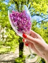 lilac in a glass on a tree background Royalty Free Stock Photo