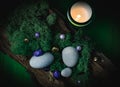 Lilac, golden stone lies in the bark of a tree with green moss, gray stones and a burning candle on a green Royalty Free Stock Photo