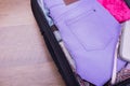 Lilac jeans in suitcase