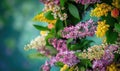 Lilac and laburnum flowers arranged in a wreath, closeup view, bokeh background Royalty Free Stock Photo