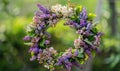 Lilac and laburnum flowers arranged in a wreath, closeup view, bokeh background Royalty Free Stock Photo