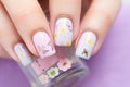 lilac nail polish with spring butterfly decals applied