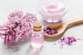 lilac natural cosmetic set for spa with salt stone table background